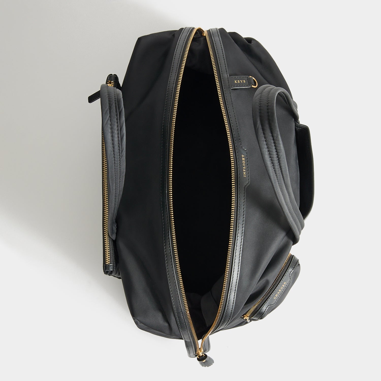 In-Flight Travel Bag -

          
            Regenerated Econyl® in Black -
          

          Anya Hindmarch EU
