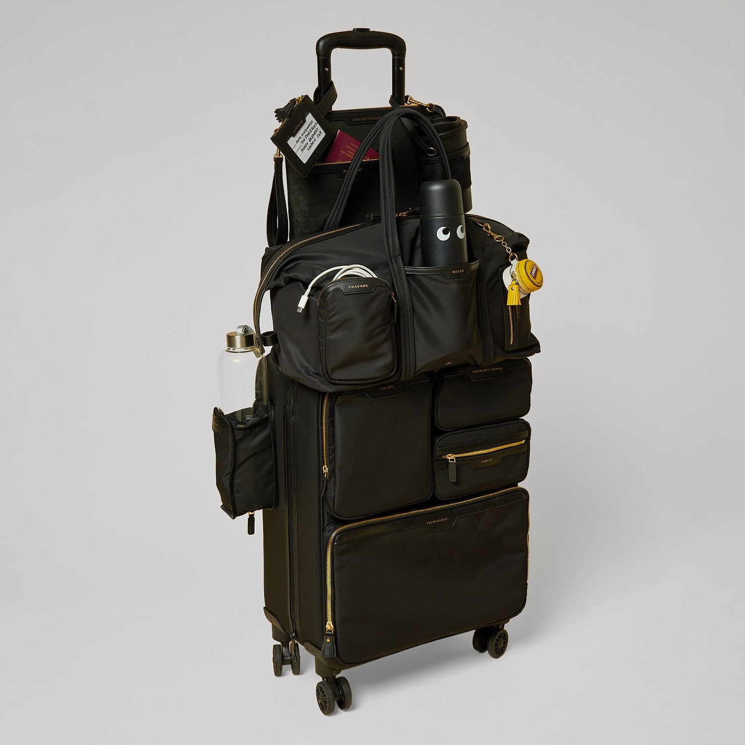 Short-Haul Suitcase -

          
            Econyl® Regenerated Nylon in Black -
          

          Anya Hindmarch EU
