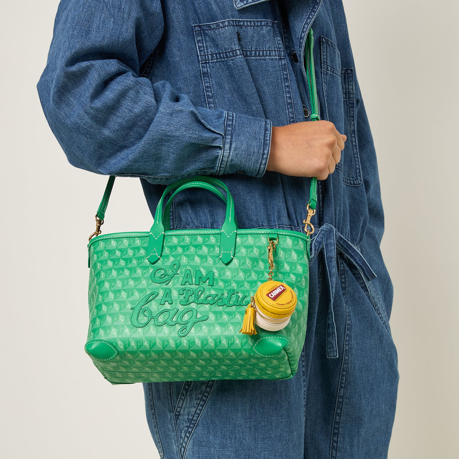 Green small tote bag with adjustable strap made of recycled plastic by anya hindmarch