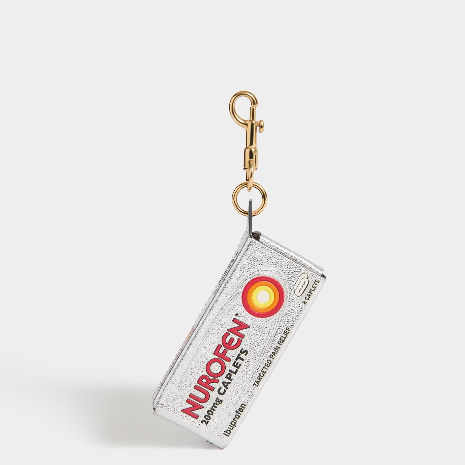 Anya Brands Nurofen Charm -

          
            Capra Leather in Metallic Silver -
          

          Anya Hindmarch EU
