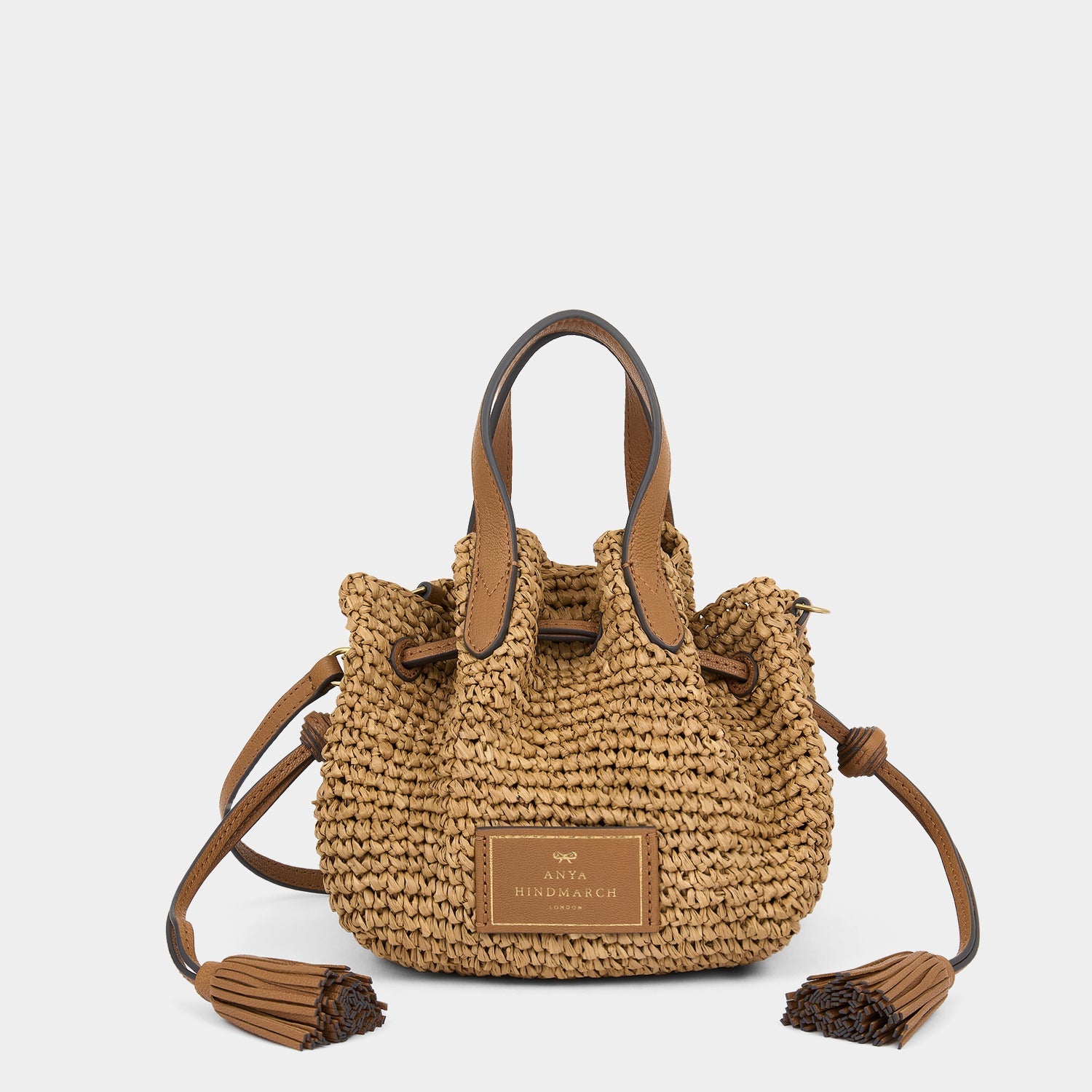 Raffia Drawstring Small Cross-body Tote -

          
            Raffia in Pecan -
          

          Anya Hindmarch EU
