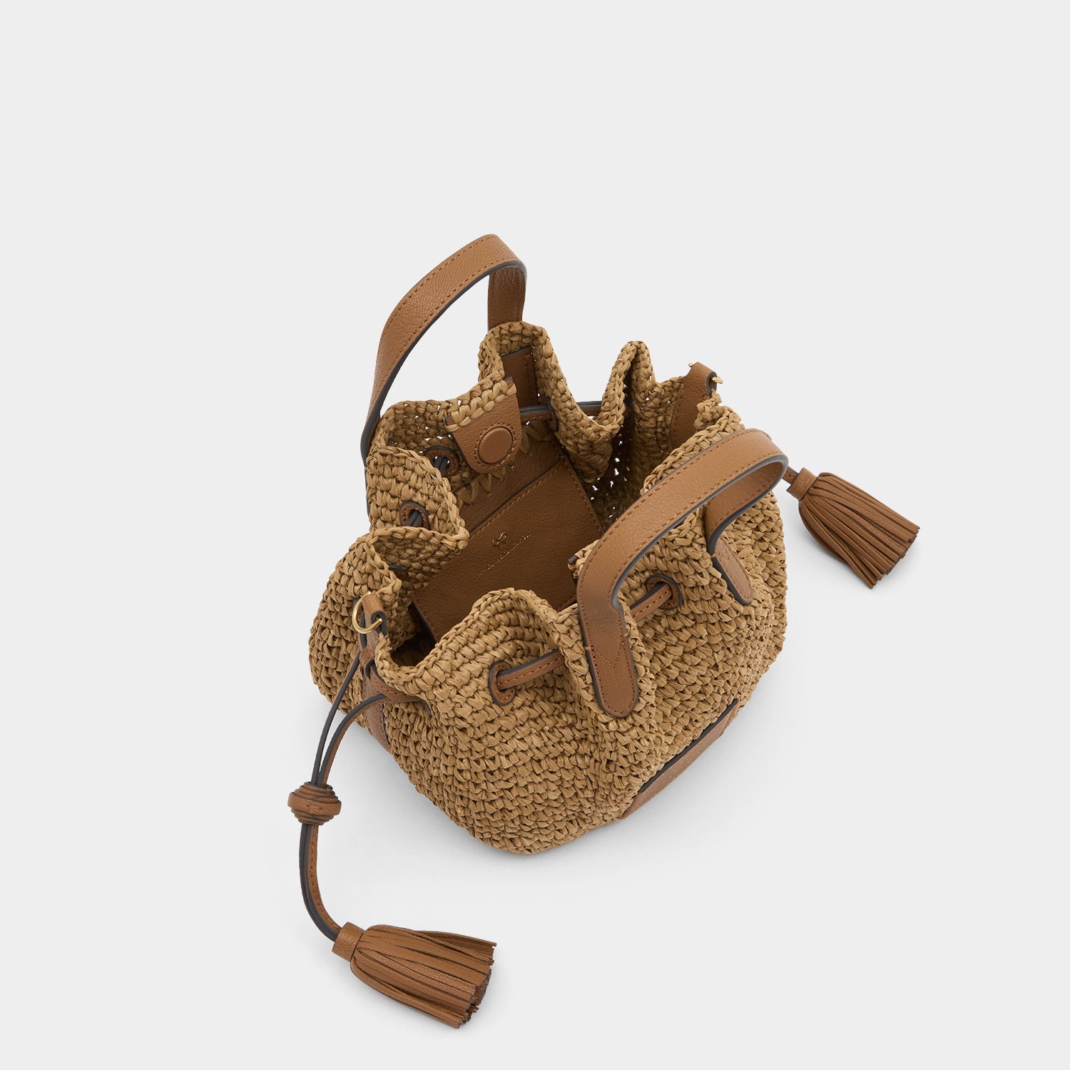 Raffia Drawstring Small Cross-body Tote -

          
            Raffia in Pecan -
          

          Anya Hindmarch EU
