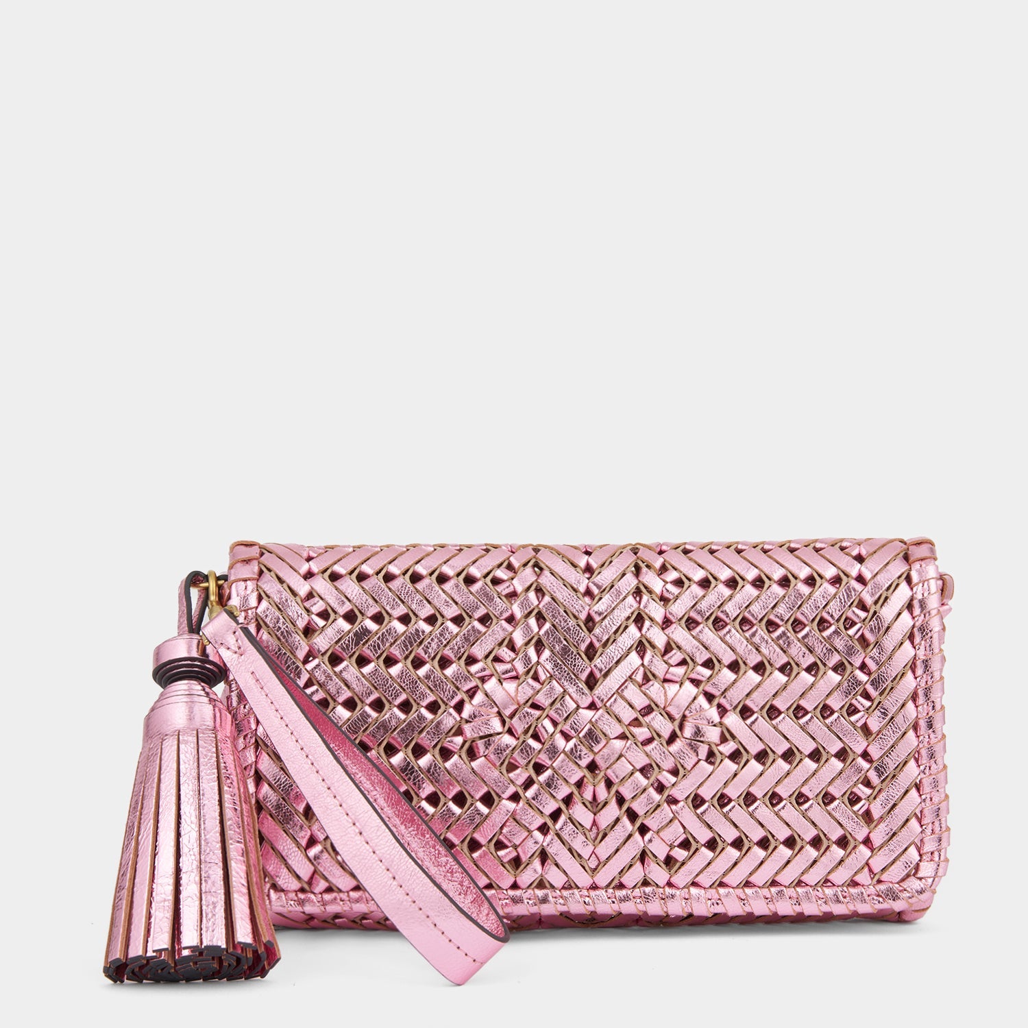 Metallic pink handwoven leather clutch bag by Anya Hindmarch