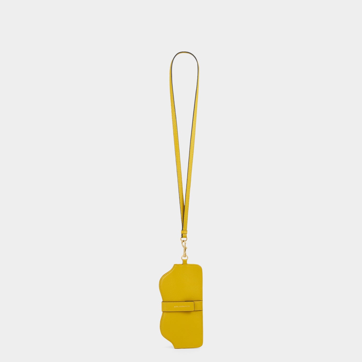Yellow leather sunglasses holder with winky face by Anya Hindmarch