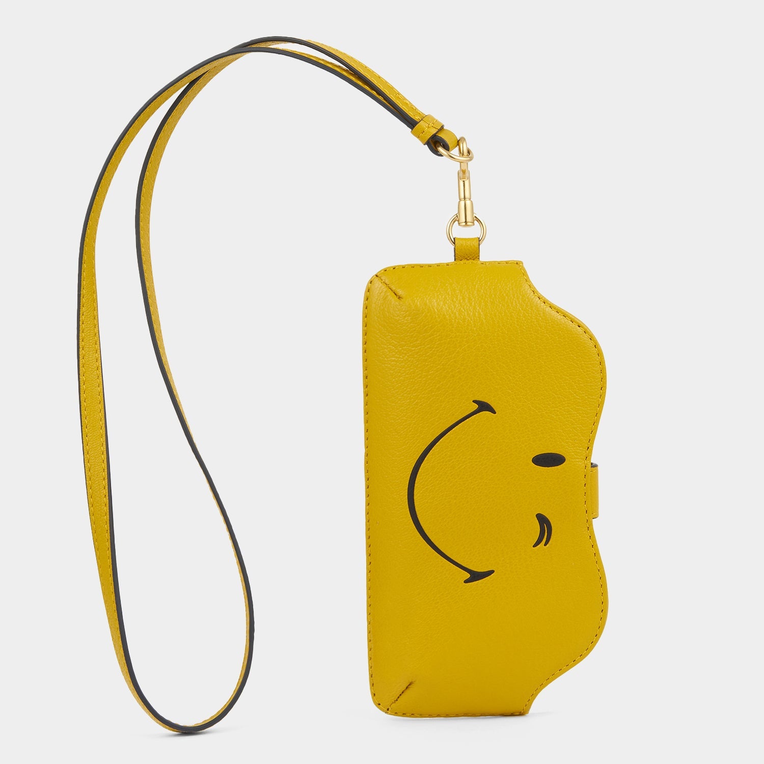 Yellow leather sunglasses holder with winky face by Anya Hindmarch