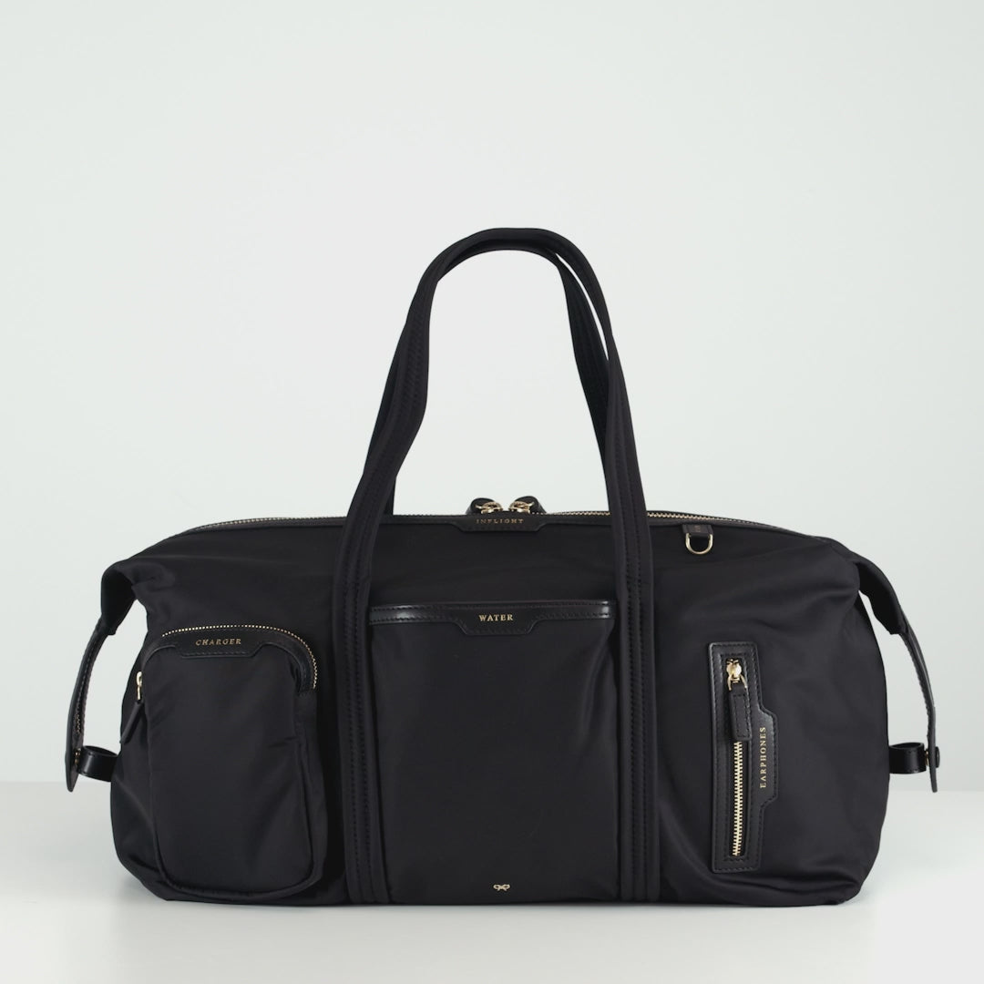 In-Flight Travel Bag -

          
            Regenerated Econyl® in Black -
          

          Anya Hindmarch EU
